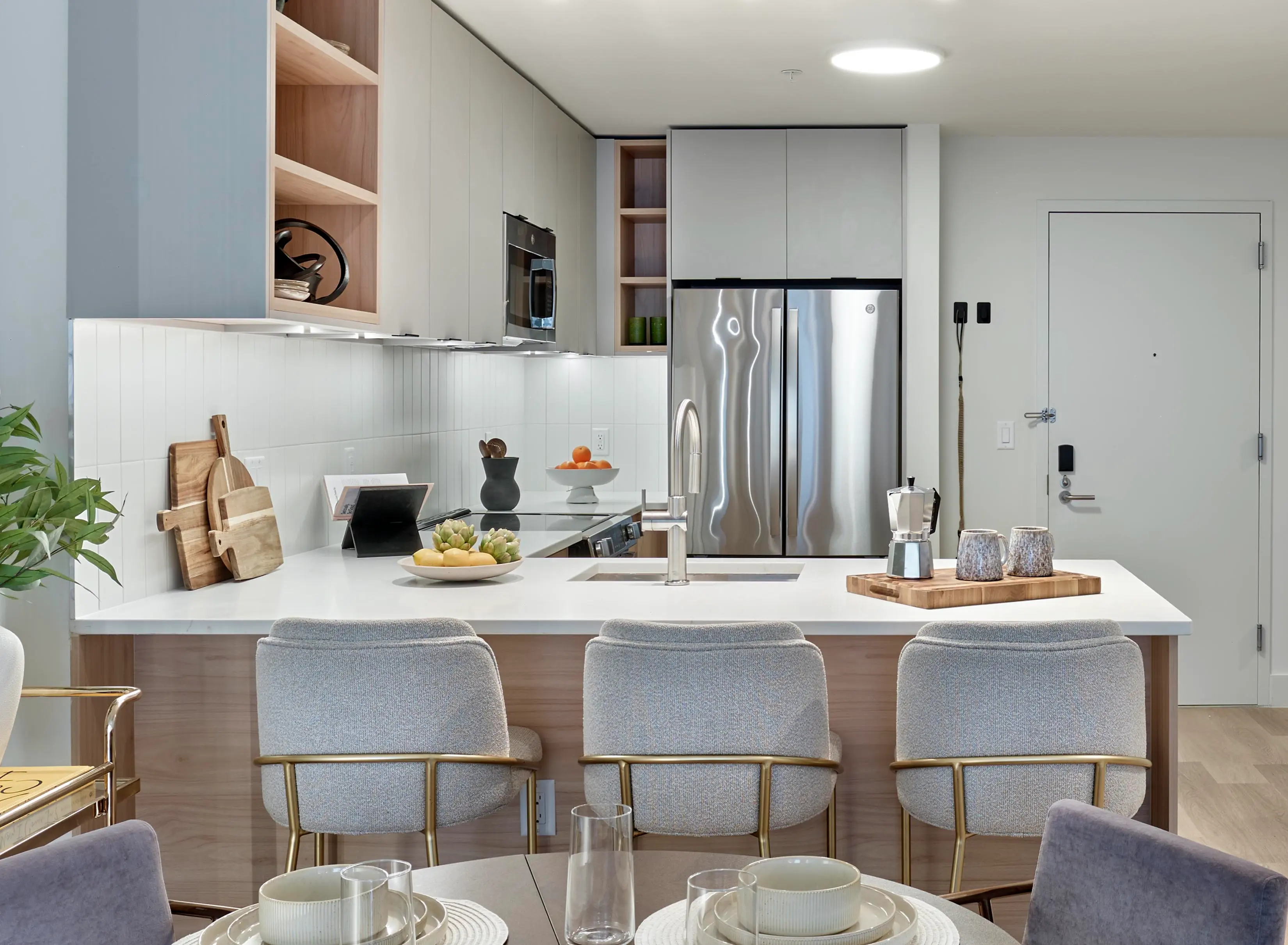 Front view of kitchen island featuring sink, dishwasher, and seating